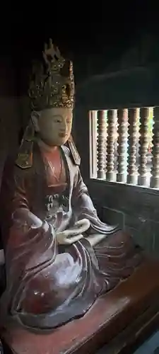 A seated figure preserved in the dim interior.