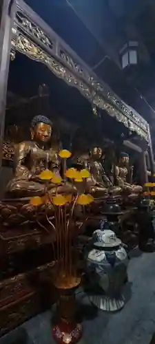 A row of gilded Buddha images within the sanctuary.